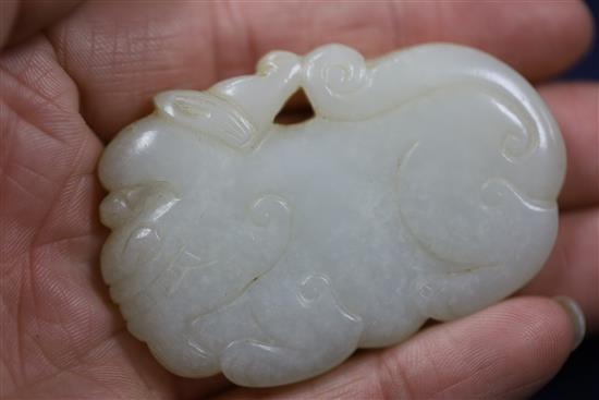 A Chinese white jade lion-dog plaque, 18th century, 6cm, wood stand